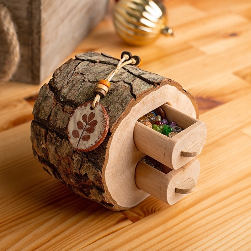 A wooden jewelry box on a wooden table.