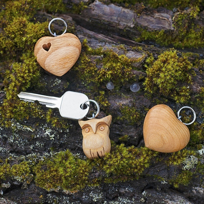 Three wooden charms on a piece of wood.
