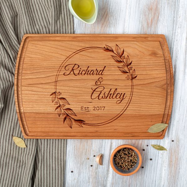 A wooden cutting board with the words richard and adelaide on it.